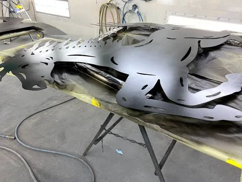 Cut metal graphics masked up in the booth