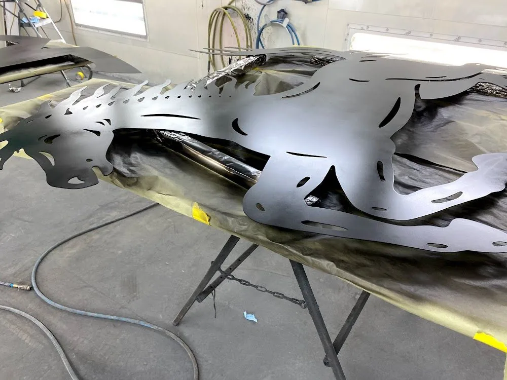 Cut metal graphics masked up on a stand in the booth
