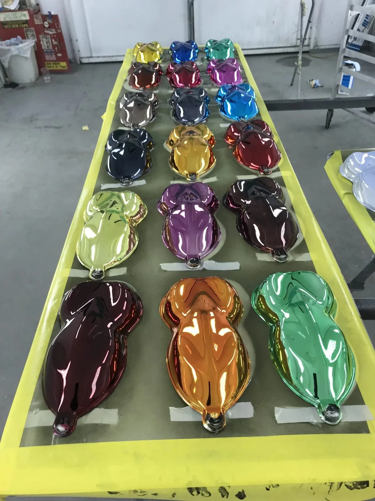 A rack of motorcycle parts finished in candy colors over chrome