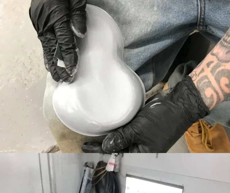 A raw part held in a gloved hand before it is prepped