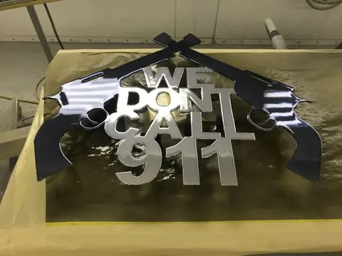A cut metal sign finished in chrome