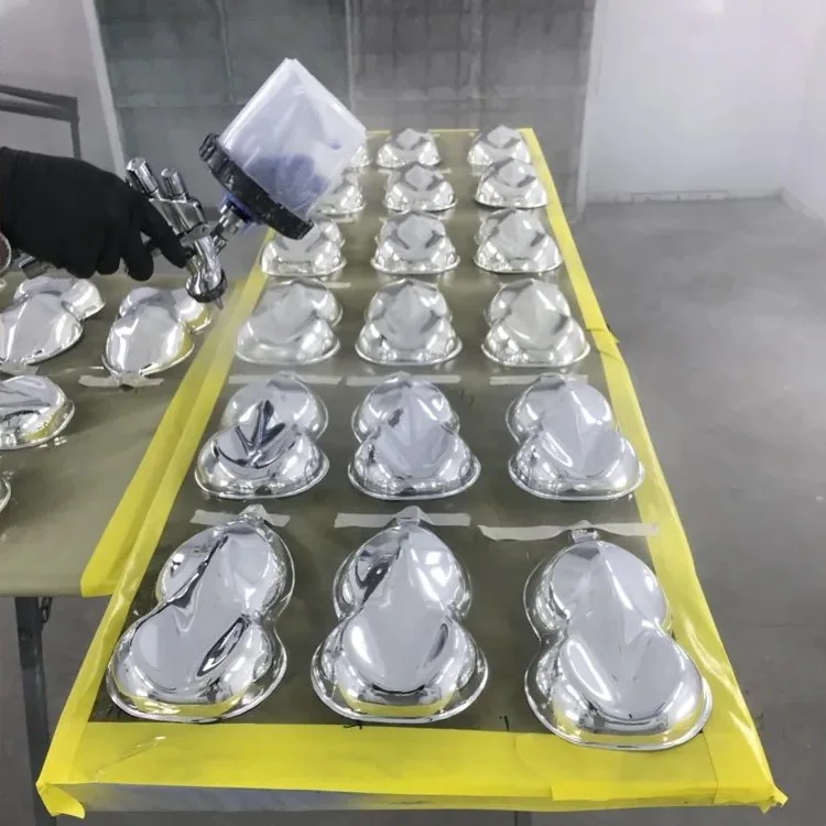 Chrome being sprayed onto a rack of masked parts