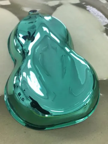 A tank shell finished in teal candy over chrome