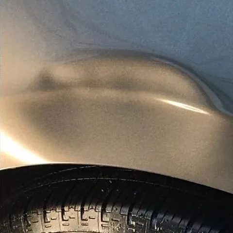 A body line reflecting cleanly under a work light after correction