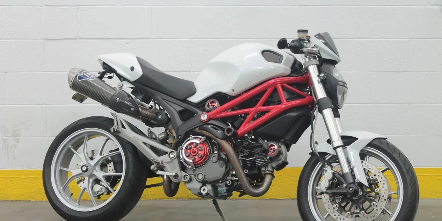 A white Ducati Monster photographed outside in daylight