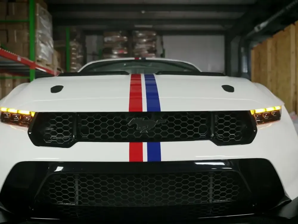 A white Mustang with tinted Lamin-x film on its headlights (photo: Lamin-x)
