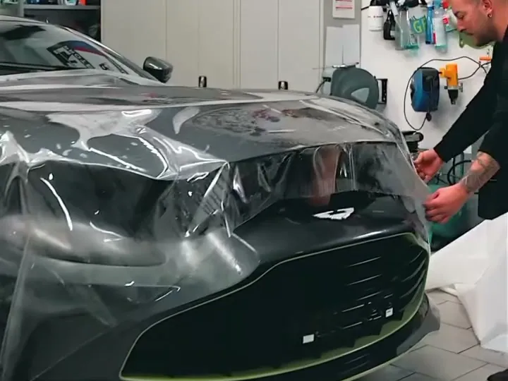 An installer fitting Ricochet clear paint protection film to the front of a car (photo: Lamin-x)