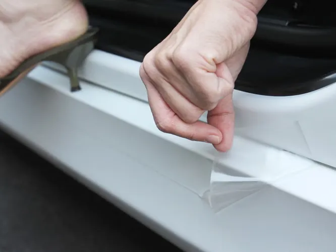 Clear film being laid on a door sill, where shoes scuff on the way in (photo: Lamin-x)