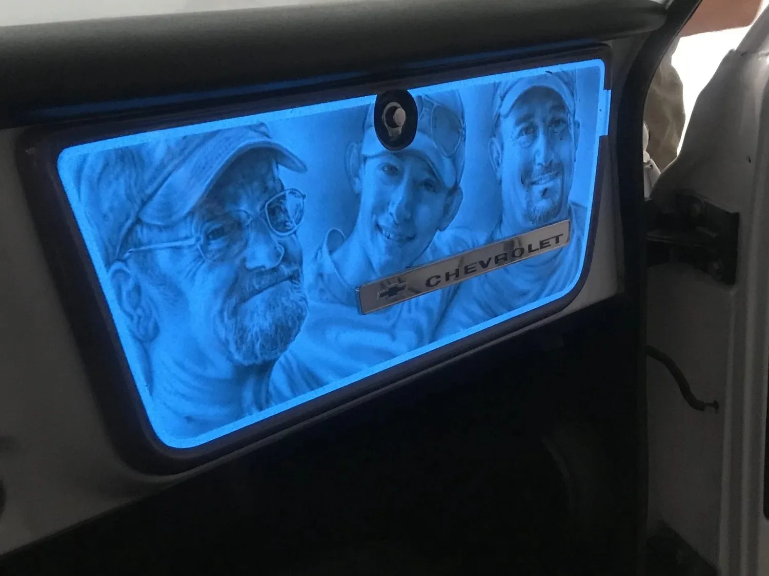 The same painted panel glowing bright cyan with the Lumilor switched on