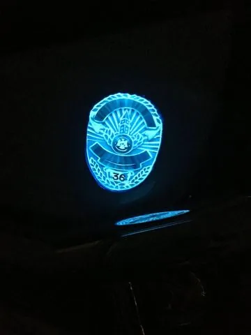A police badge design lit up on a tank