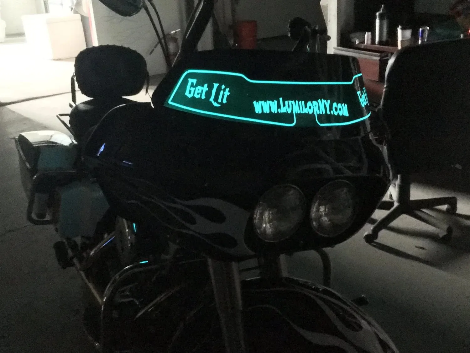 A motorcycle fairing with glowing lettering along the top
