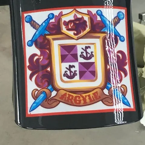 A hand painted crest on a bike in daylight