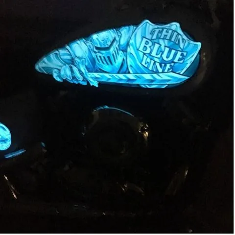 A Thin Blue Line tank glowing in Lumilor